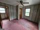 Bedroom showcasing wood-paneled walls, carpeted flooring, natural light and a ceiling fan at 125 Rosenwald Cir, Stockbridge, GA 30281