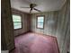 Bedroom with wood-paneled walls, carpeted flooring, natural light, and ceiling fan at 125 Rosenwald Cir, Stockbridge, GA 30281