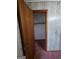 Walk-in closet view, showing a built-in rod and shelf for storage, and a carpeted floor at 125 Rosenwald Cir, Stockbridge, GA 30281