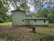 Backyard showing the home's exterior surrounded by mature trees and foliage at 125 Rosenwald Cir, Stockbridge, GA 30281
