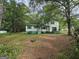 Two-story home with green trim surrounded by mature trees in an establishing neighborhood at 125 Rosenwald Cir, Stockbridge, GA 30281