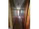 Hallway leading to a bathroom with wood-paneled walls and carpeted flooring at 125 Rosenwald Cir, Stockbridge, GA 30281