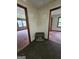 Hallway area featuring multiple doorways to various rooms, with neutral carpeting throughout at 125 Rosenwald Cir, Stockbridge, GA 30281