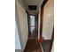 Hallway with hardwood flooring and visible access doors leading to other rooms at 125 Rosenwald Cir, Stockbridge, GA 30281