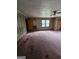 Spacious living room featuring paneled walls, stained carpet, and a vintage ceiling fan at 125 Rosenwald Cir, Stockbridge, GA 30281
