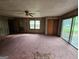 Cozy living room with wood-paneled walls, and lots of natural light perfect for relaxing at 125 Rosenwald Cir, Stockbridge, GA 30281