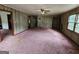 Inviting living room featuring wood-paneled walls and ample space for entertaining guests at 125 Rosenwald Cir, Stockbridge, GA 30281