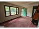 Living room area with natural light, fireplace, and a view of the lush outdoors at 125 Rosenwald Cir, Stockbridge, GA 30281