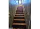 Stairway with wood steps, a handrail, and paneled walls at 125 Rosenwald Cir, Stockbridge, GA 30281