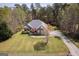 Beautiful aerial view of a home with a spacious yard, complemented by mature trees and a private driveway at 50 Clear Spring Ct, Oxford, GA 30054