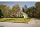 Well-maintained home showcasing a spacious yard, driveway, and mature trees, offering a serene setting at 50 Clear Spring Ct, Oxford, GA 30054