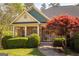 Inviting front porch with classic architectural details, complemented by landscaped greenery and a brick facade at 50 Clear Spring Ct, Oxford, GA 30054