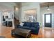Open-concept living room featuring hardwood floors, neutral tones, and seamless transition to dining and kitchen at 50 Clear Spring Ct, Oxford, GA 30054