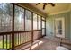 Inviting screened porch with wood floors, ceiling fan, and views of the lush backyard at 50 Clear Spring Ct, Oxford, GA 30054
