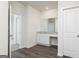 Bathroom vanity features granite countertops and a large mirror, complemented by wood-look flooring at 236 Oliver Dr, Locust Grove, GA 30248