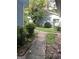 Backyard featuring a lush green lawn, bordered by trees and a stone walkway at 8596 Creekwood Way, Jonesboro, GA 30238