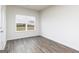 Bright bedroom with hardwood floors, a large window, and fresh white walls at 256 Oliver Dr, Locust Grove, GA 30248