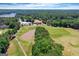 Overhead image showcasing the lush landscaping of the golf course and its proximity to the lake at 660 Milton Dr, Mcdonough, GA 30252