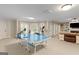 Recreational basement area with ping pong table, workout equipment, and comfortable living space at 660 Milton Dr, Mcdonough, GA 30252
