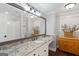 Bathroom features granite vanity, white cabinets, oversized mirror, and hardwood floors at 660 Milton Dr, Mcdonough, GA 30252