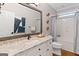 Bathroom featuring a granite vanity with white cabinets, tile floors, and a shower/tub combo at 660 Milton Dr, Mcdonough, GA 30252