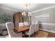 Formal dining room featuring stylish chairs, hardwood table, chandelier, and neutral wall colors at 660 Milton Dr, Mcdonough, GA 30252