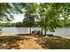 Private lake dock with benches, surrounded by mature trees offering a tranquil waterfront escape at 660 Milton Dr, Mcdonough, GA 30252
