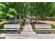 Wooden dock featuring built-in benches and scenic lake views surrounded by mature trees at 660 Milton Dr, Mcdonough, GA 30252