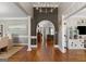 Elegant foyer with hardwood floors, arched doorway, and decorative lighting fixtures at 660 Milton Dr, Mcdonough, GA 30252