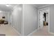 Neutral hallway with carpet, white trim, and several doorways leading to other rooms at 660 Milton Dr, Mcdonough, GA 30252