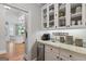 Kitchen features granite countertops, stainless steel dishwasher, and overhead glass door cabinets at 660 Milton Dr, Mcdonough, GA 30252
