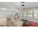 Relaxing living room with neutral sofa, rug, and coffee table, with exercise equipment in the background at 660 Milton Dr, Mcdonough, GA 30252