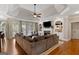 Spacious living room with tray ceilings, fireplace, built-in shelving, and a comfortable sectional sofa at 660 Milton Dr, Mcdonough, GA 30252