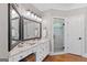 The main bathroom features double sinks, granite countertop, white cabinetry, and a glass shower at 660 Milton Dr, Mcdonough, GA 30252