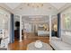 Hardwood floors throughout the main bedroom lead to the sitting room, with its cathedral ceilings and chandelier at 660 Milton Dr, Mcdonough, GA 30252
