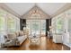 Sitting area has cathedral ceilings, hardwood floors, picture windows, and a decorative chandelier at 660 Milton Dr, Mcdonough, GA 30252