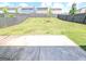 Large backyard with a wooden privacy fence and a newly planted tree at 120 Magnaview Dr, Mcdonough, GA 30253