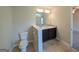 Well-lit bathroom featuring a double vanity with granite countertop and a separate toilet area at 120 Magnaview Dr, Mcdonough, GA 30253