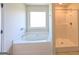 Bright bathroom showcasing a large soaking tub and a separate shower with glass doors at 120 Magnaview Dr, Mcdonough, GA 30253