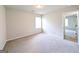 Cozy bedroom with neutral carpet, a window, and an open doorway to another room at 120 Magnaview Dr, Mcdonough, GA 30253