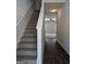 Entryway with carpeted stairs and view of hardwood floors to the living room at 120 Magnaview Dr, Mcdonough, GA 30253