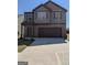 Two-story home featuring a brick and siding facade with a two-car garage and concrete driveway at 120 Magnaview Dr, Mcdonough, GA 30253
