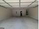 Spacious garage with concrete floors, an automatic door opener, and a door to the house at 120 Magnaview Dr, Mcdonough, GA 30253