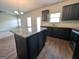 Modern kitchen island with dark wood cabinets, granite countertops, and hardwood floors at 120 Magnaview Dr, Mcdonough, GA 30253
