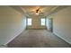 Main bedroom featuring carpet, a trey ceiling with fan, and two windows at 120 Magnaview Dr, Mcdonough, GA 30253