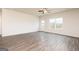 Bright, airy living room featuring wood-look floors, a window, and a door leading to the backyard at 232 Oliver Dr, Locust Grove, GA 30248
