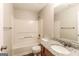 Bathroom featuring a tub/shower combo, neutral walls and flooring, and modern fixtures at 3796 Wolverton Cir, Lithonia, GA 30038