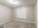 Bedroom with neutral carpet, and a window with white blinds, offering a simple and comfortable space at 3796 Wolverton Cir, Lithonia, GA 30038