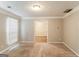 Bedroom showcasing neutral carpet, paint, a bright window, and a door leading to an adjacent room at 3796 Wolverton Cir, Lithonia, GA 30038