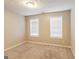 Bedroom with neutral carpeting, a ceiling fan, and two windows with white blinds at 3796 Wolverton Cir, Lithonia, GA 30038